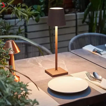 A sleek modern led mosaic table lamp with matte bronze finish and cylindrical shade for bedroom lighting and wireless charging