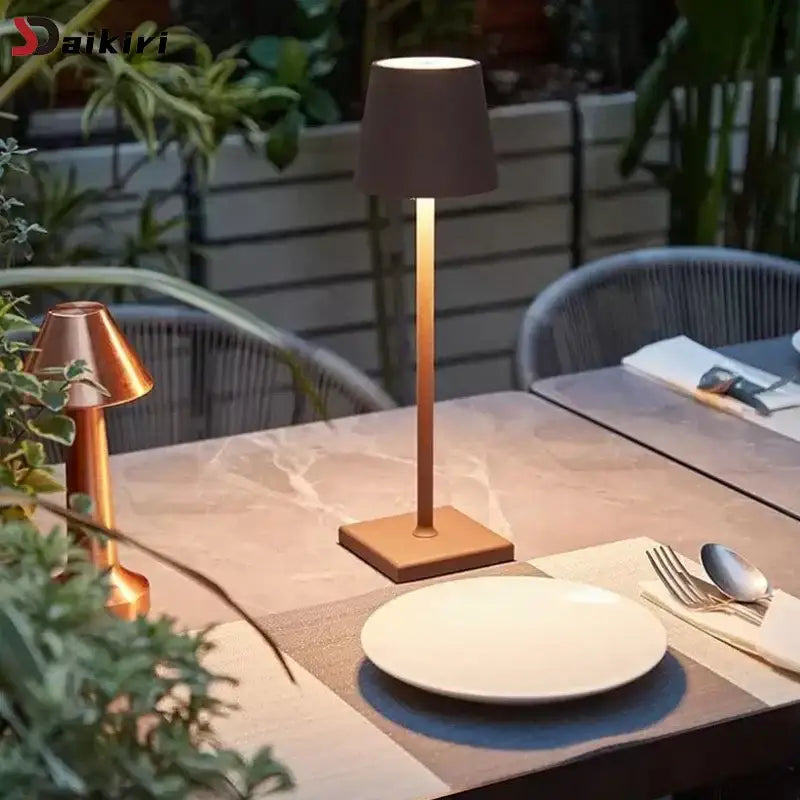 A sleek modern led mosaic table lamp with matte bronze finish and cylindrical shade for bedroom lighting and wireless charging