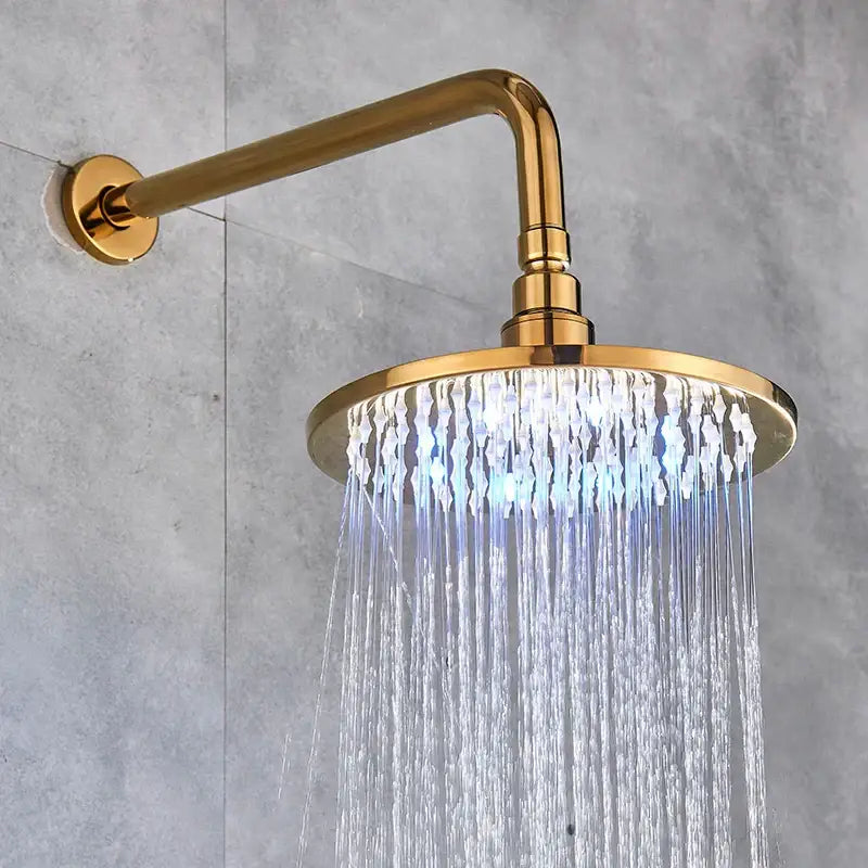 Modern led round gold shower head with crystal droplet design and curved arm mounted on the wall for bathroom use