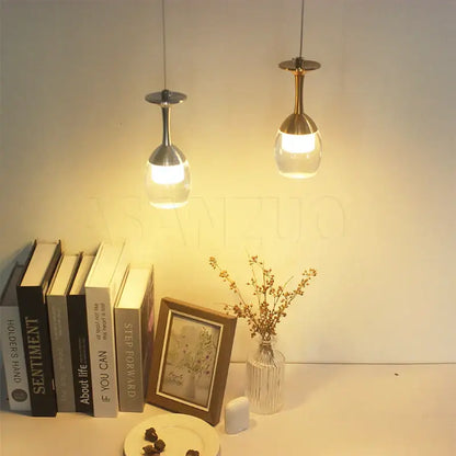 Two modern pendant lights with metallic stems and clear glass globes for dining room decorbites led wine chandelier