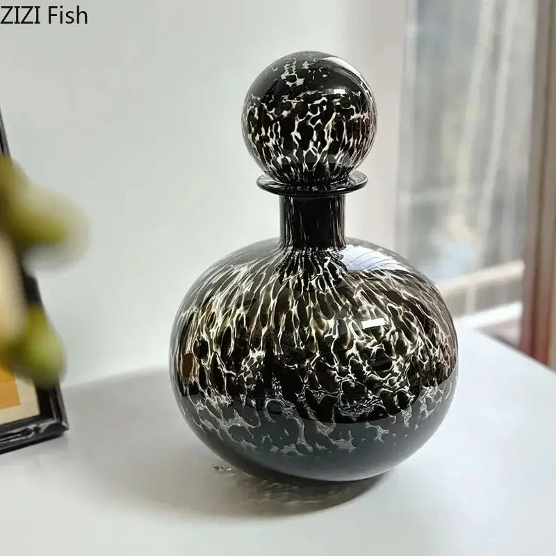 Elegant black glass decanter with swirling white marbled pattern and decorbites leopard texture for dining room decor