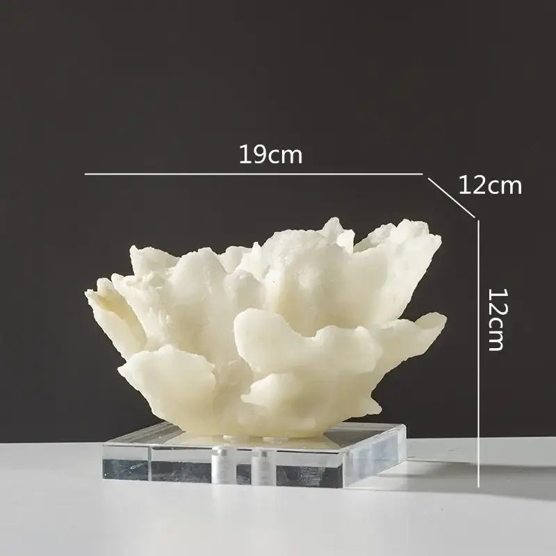 Off-white intricately textured coral resin sculpture on clear acrylic base for modern light blue living room decor
