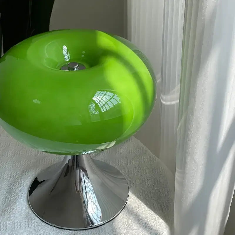Modern lime green resin stool with glossy finish and chrome pedestal base for decorbites glass desk office use