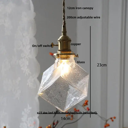 A warm-glowing modern lime and teal blue decorbites bubble glass ball pendant light with brass copper fixture and iron canopy