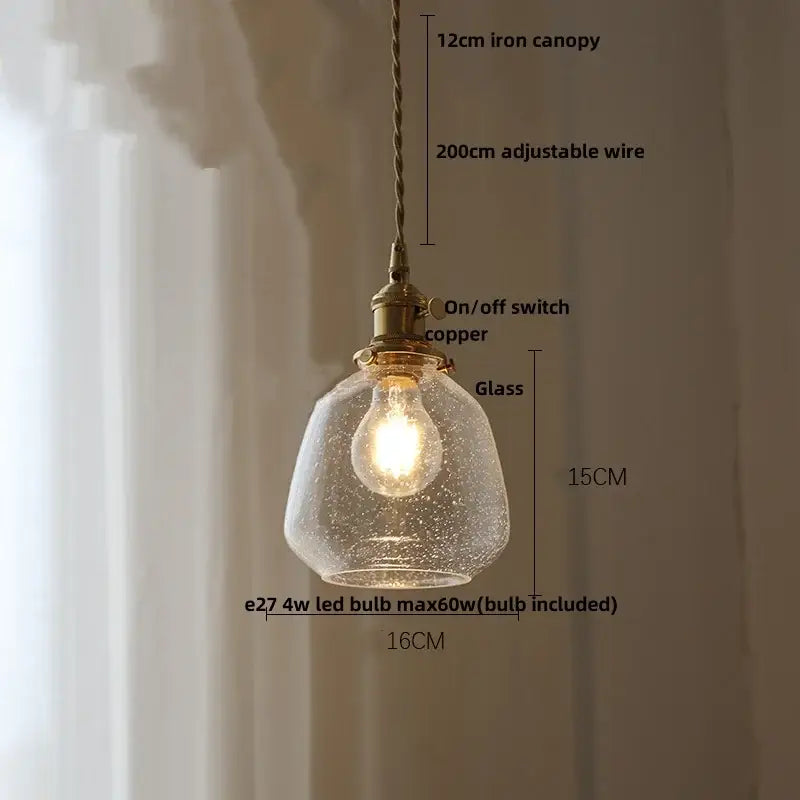 Modern lime and teal bubble glass ball pendant light with warm glowing speckled glass and brass-toned decorbites bubble glass hardware