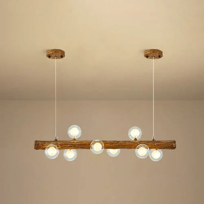 Rustic wooden beam pendant light with six clear glass globe bulbs in a brown modern linear island pendant lamp