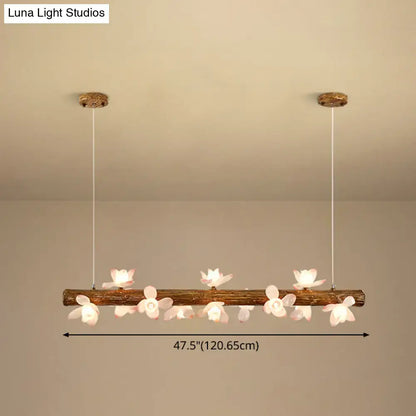 Rustic wooden log brown modern linear island pendant metal lamp adorned with delicate white flower fixtures by decorbites