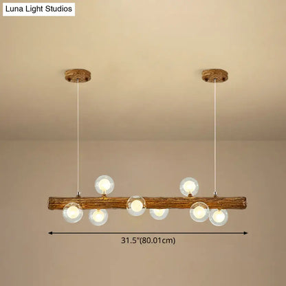 Rustic wooden log pendant light with six clear glass globes in a brown modern linear island metal lamp by decorbites