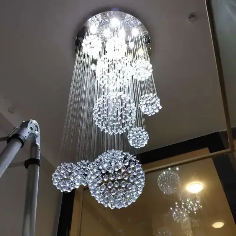 A modern luxury crystal ball led chandelier with cascading crystal spheres on a sleek metallic frame for living room decorbites