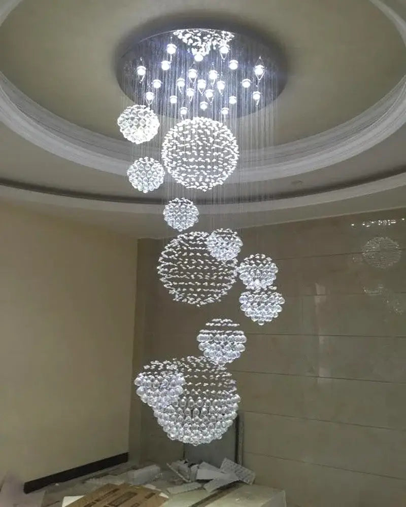 A modern luxury decorbites crystal ball led chandelier with clear faceted glass spheres for living room pendant light