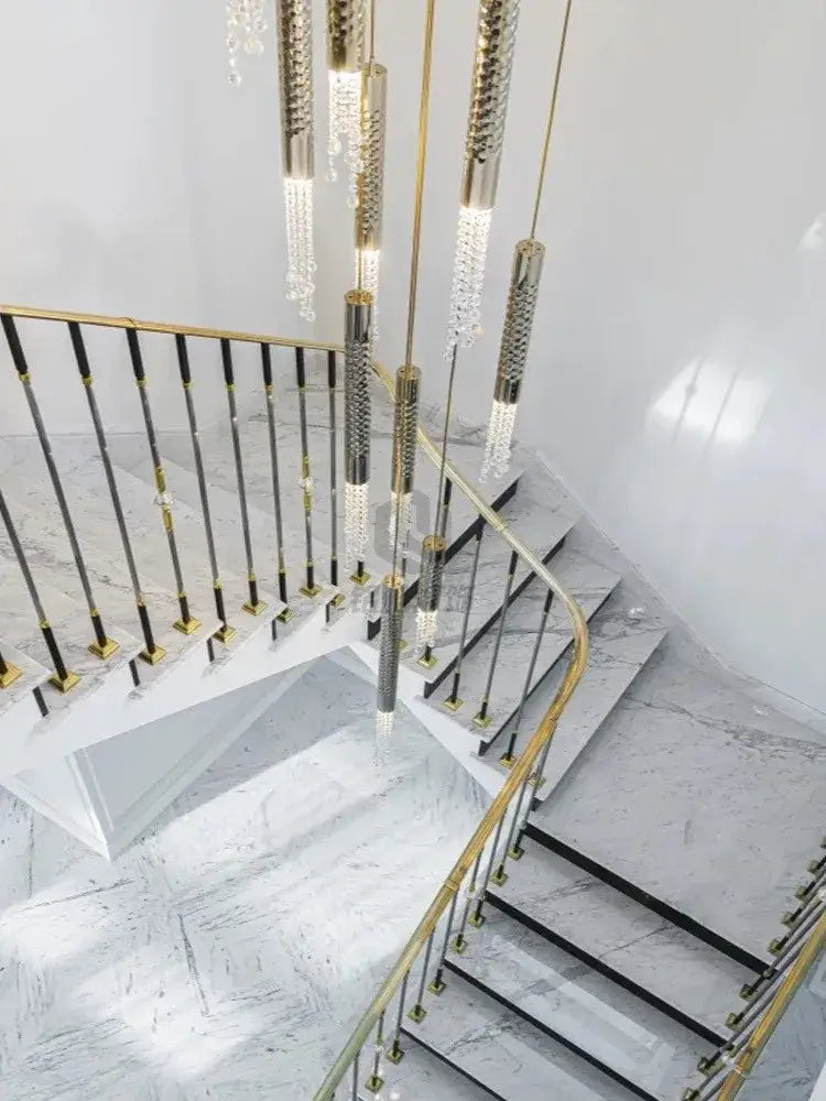 Gold-toned modern luxury crystal led staircase chandelier with cascading pendants and textured metallic rods for living room decorbites crystal led