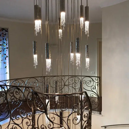 Modern luxury crystal led staircase chandelier with cylindrical metallic fixtures and cascading crystal droplets by decorbites