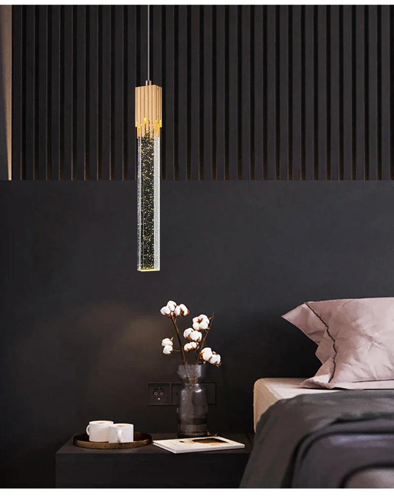Modern luxury crystal pendant lamp with cylindrical glass body filled with sparkling particles and golden cap for home decor