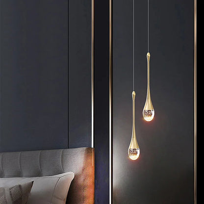 Two elegant gold-toned crystal pendant lamps with clear glass bodies and sparkling elements for modern home decor