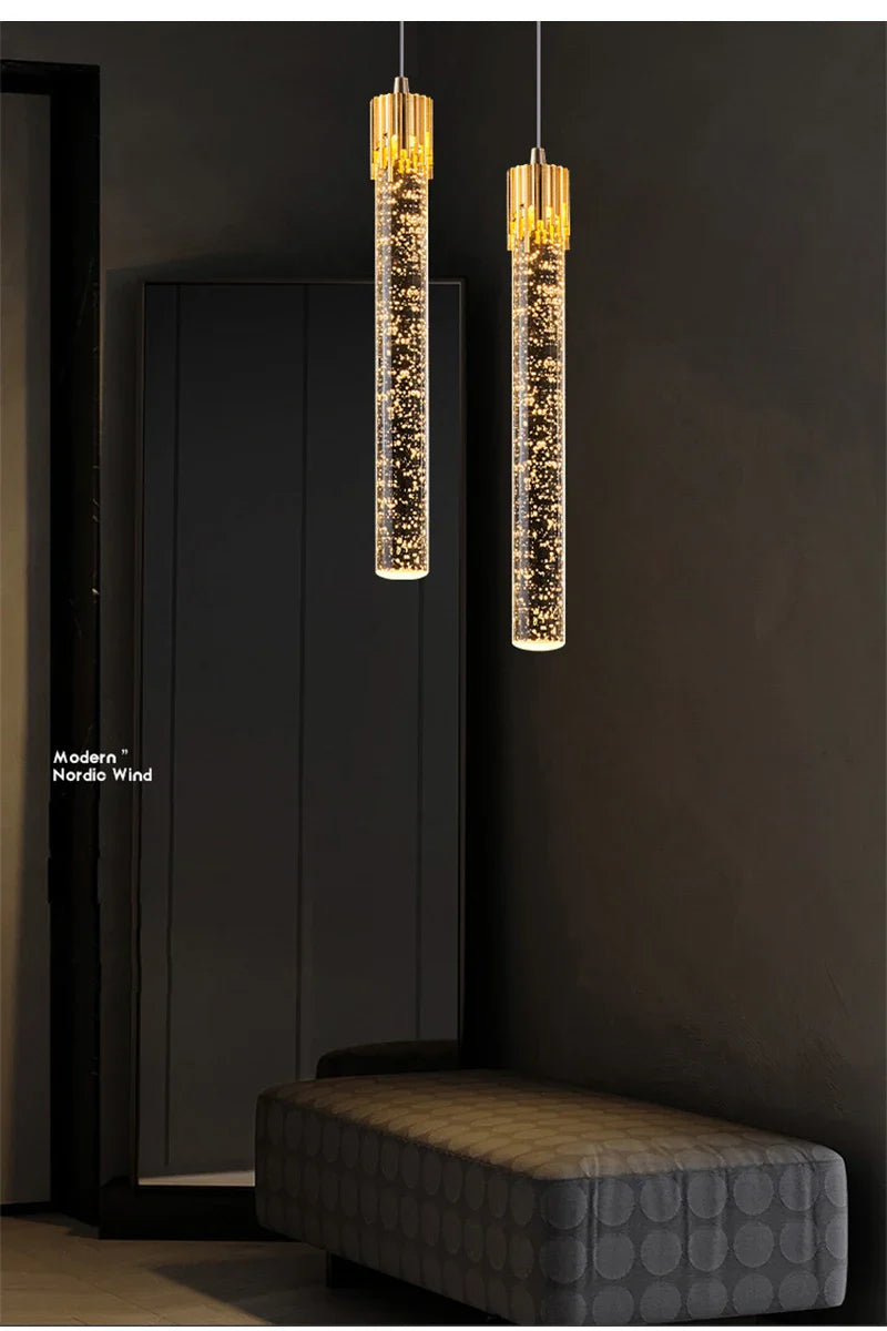 Two elegant gold-toned cylindrical crystal pendant lamps with sparkling LED effects for modern home decor lighting