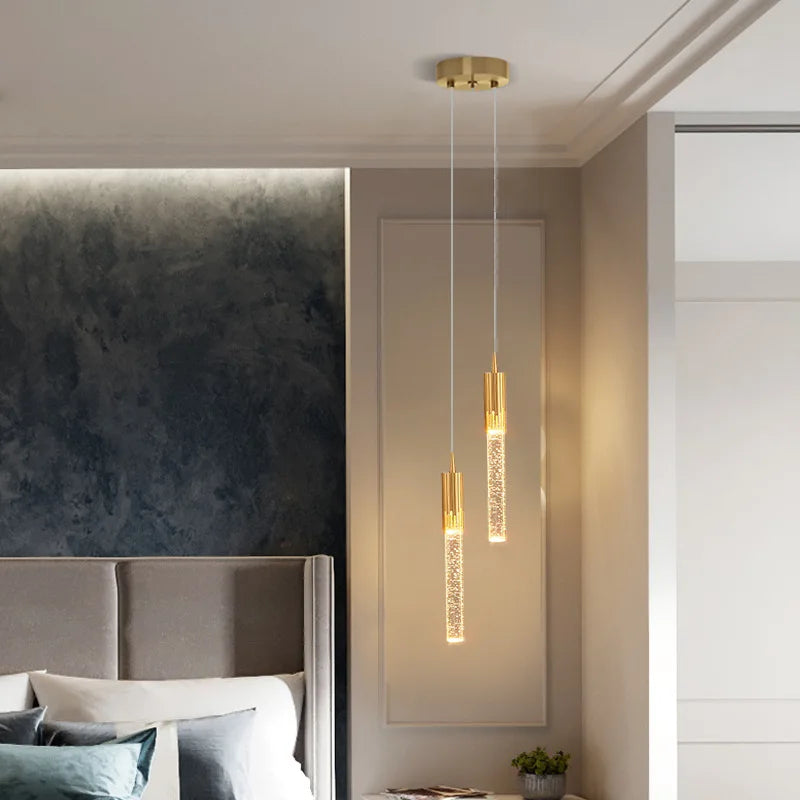 Gold-toned modern luxury crystal pendant lamps with sparkling accents hanging from ceiling for living room and bedroom decor