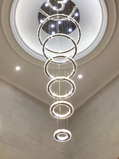 A modern luxury crystal rings chandelier with polished chrome concentric rings and embedded led lights by decorbites crystal