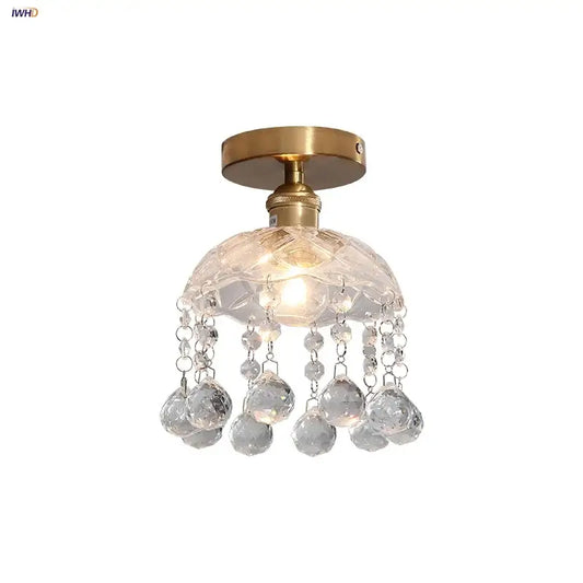 A modern luxury decorbites crystal glass ceiling lamp with brass finish and faceted spherical crystals for living room