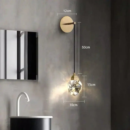 A modern luxury gold crystal led wall sconce with a faceted clear glass globe for bedroom decorbites crystal led lighting