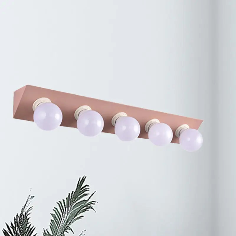 Rose gold rectangular vanity sconce with five frosted globe bulbs modern macaron pink and yellow 5-light sconce light