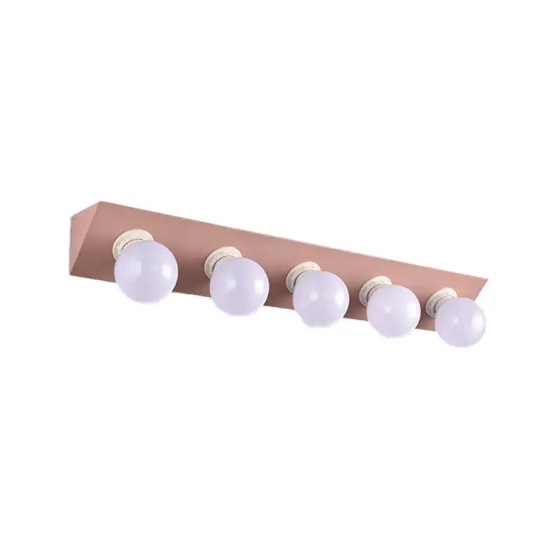 Rose gold rectangular vanity sconce with five spherical frosted glass bulbs for modern bathroom lighting