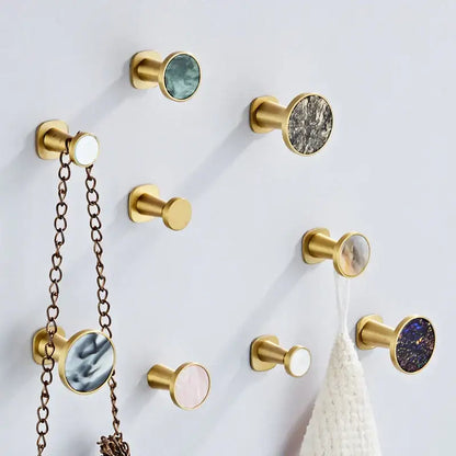 Modern marbled stone towel hook with decorbites brushed gold finish and circular mother of pearl inlays for bathroom decor
