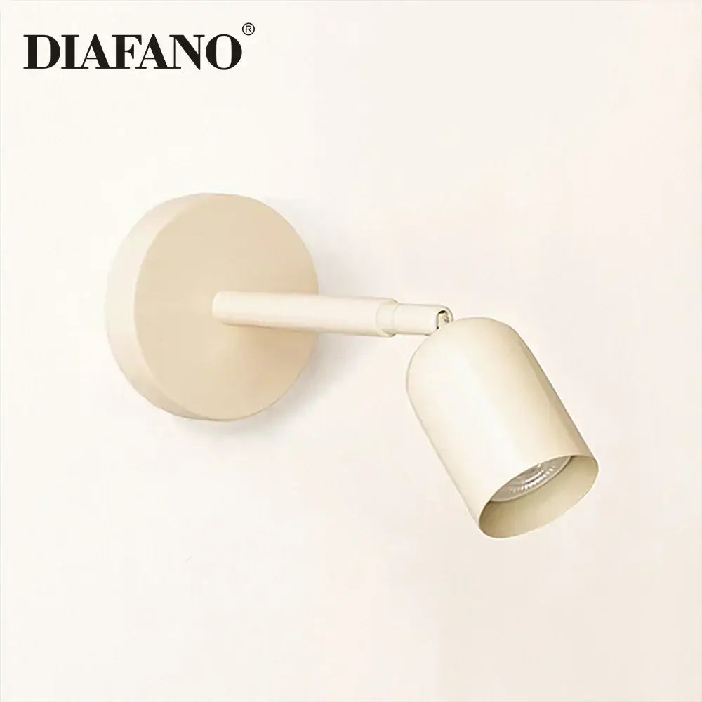 Cream-colored diafano matte wall sconce with cylindrical head and adjustable arm featuring gu10 led for bedroom use