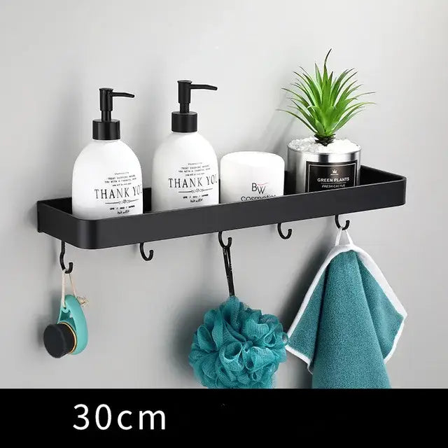Modern matte black aluminum corner shelf with hooks holding toiletries and plant decorbites black aluminum bathroom storage holder