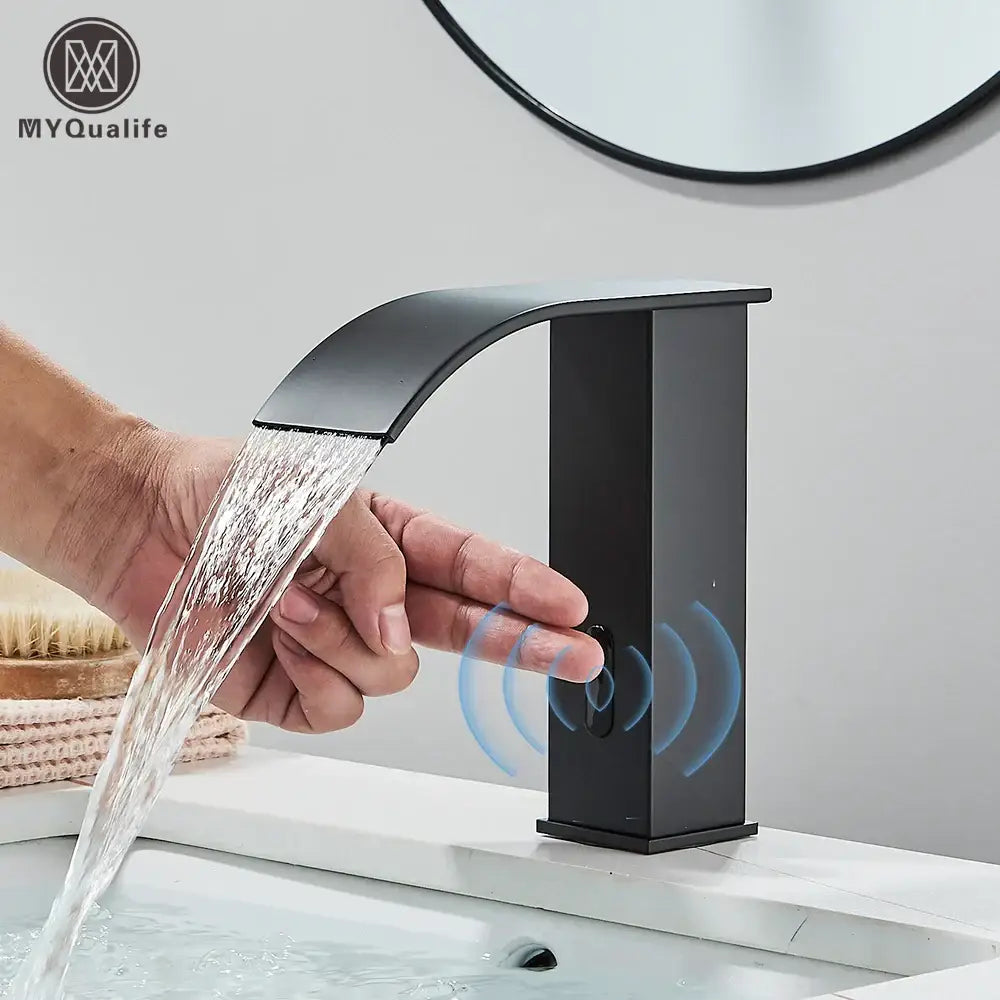 Modern matte black automatic sensor waterfall basin faucet with sleek curved spout and rectangular base for bathroom sink