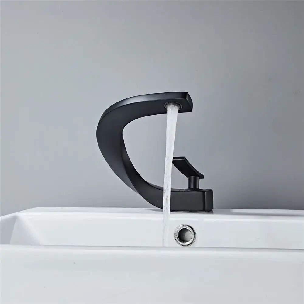 Modern matte black basin faucet with sleek curved design and black matte finish for bathroom hot cold mixing tap decorbites black basin