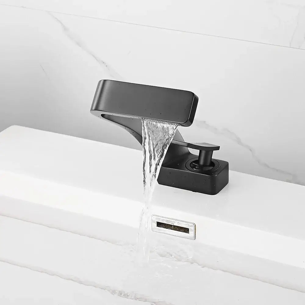 Modern matte black basin faucet with waterfall spout and single lever handle in a sleek matte finish design