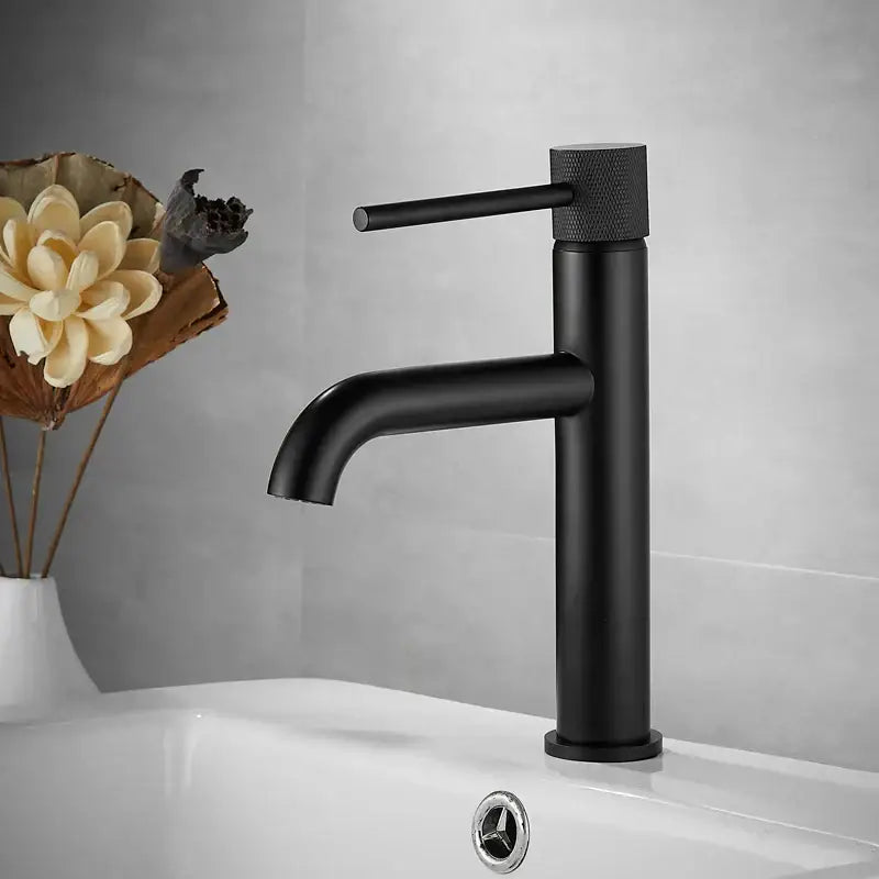 Modern matte black basin faucet with textured cylindrical handle and minimalist design for bathroom sink mixer tap