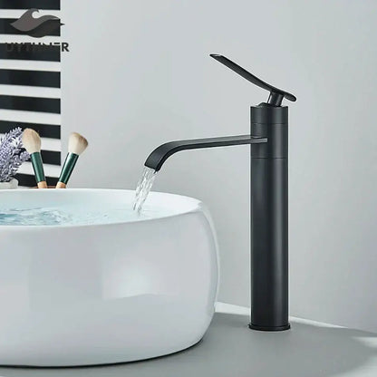 Modern matte black basin faucet mixer with curved spout flowing water into white ceramic sink decorbites basin faucet
