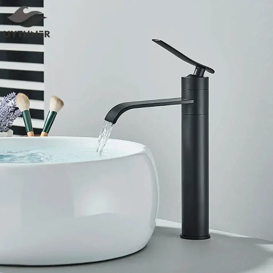 Modern matte black basin faucet mixer with curved spout flowing water into white ceramic sink decorbites basin faucet