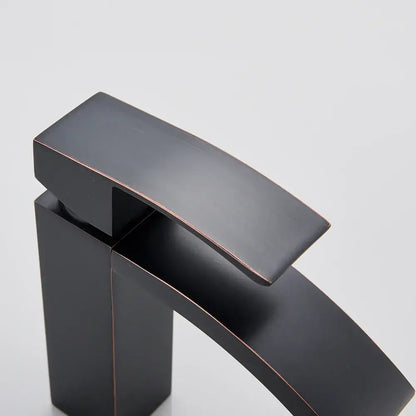 Modern matte black basin mixer faucet with sleek angular design and copper accents for bathroom curved spout use