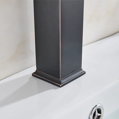 A sleek modern matte black basin mixer faucet with a rectangular column design and dark bronze metallic edges