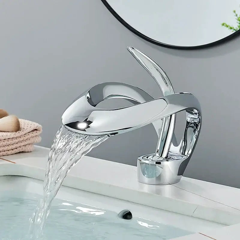 Chrome finished modern waterfall basin faucet with sleek sculptural design for bathroom vanity tap in matte black brass