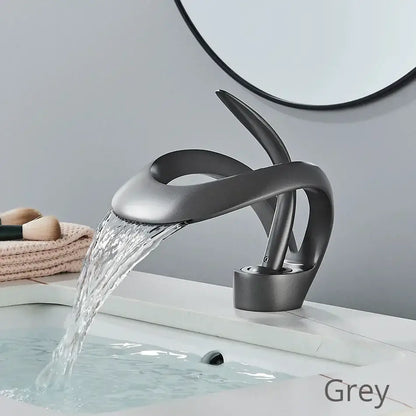 Modern matte grey waterfall basin faucet with sleek sculpted design made of brass for bathroom vanity use