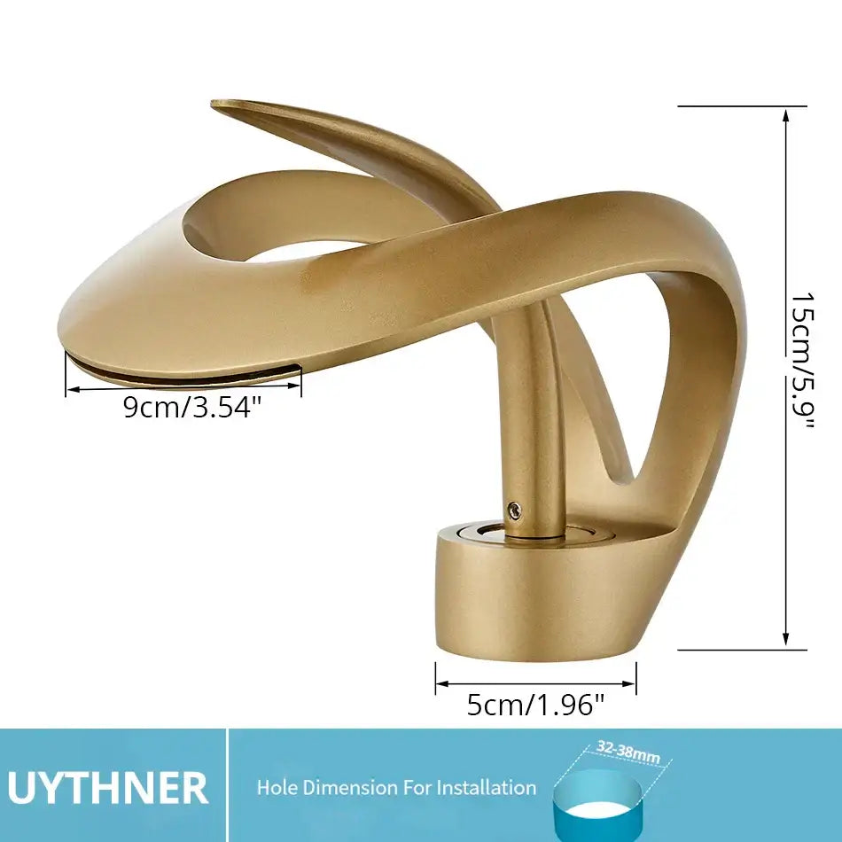 Gold-colored sleek curved waterfall basin faucet in matte black brass for modern bathroom vanity use