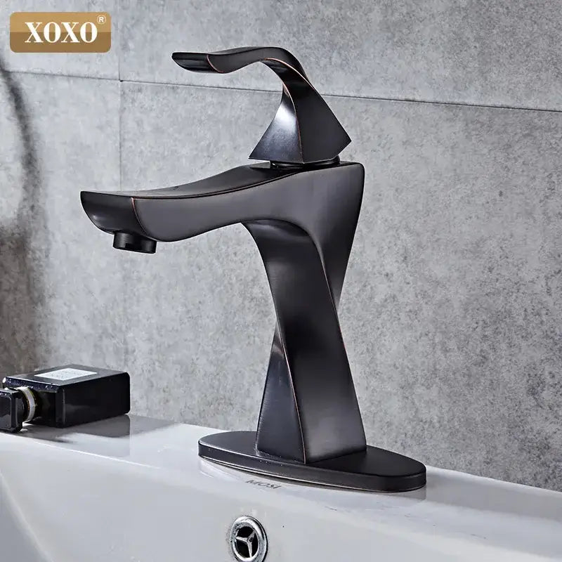 Modern matte black xoxo basin faucet with sleek angular contours in decorbites contemporary brass basin design