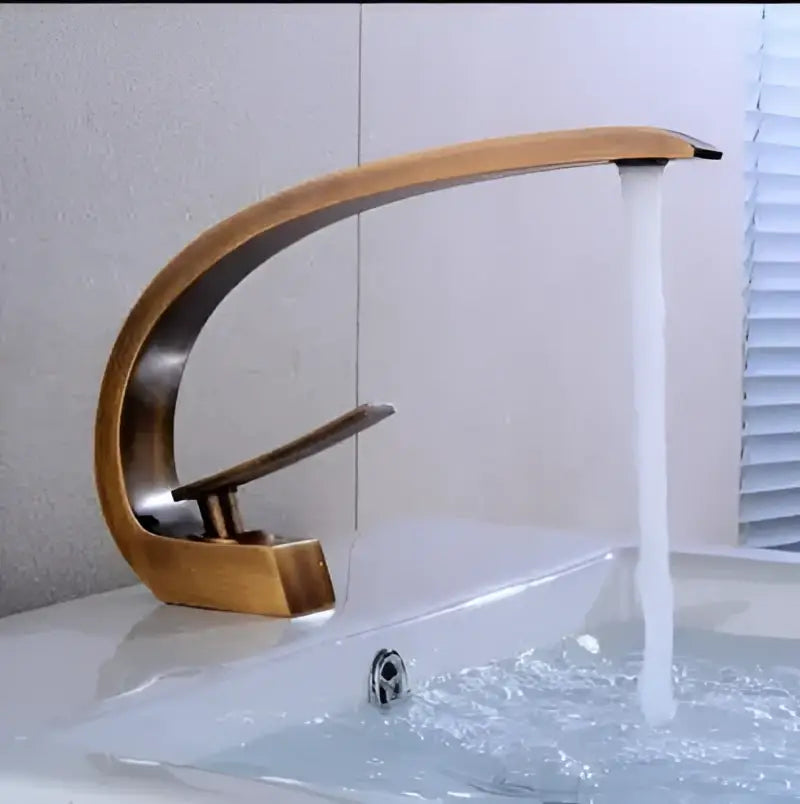 Bronze-finished curved waterfall basin faucet with sleek modern design for gold modern basin bathroom use