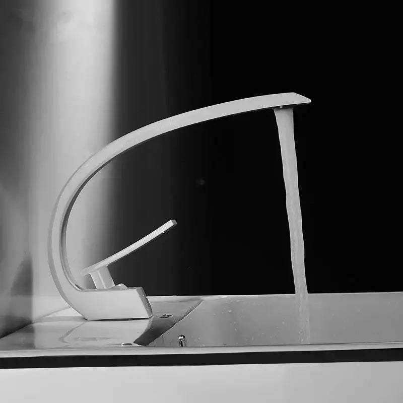 Modern chrome-finished basin faucet with sleek curved design and single lever handle for bathroom use