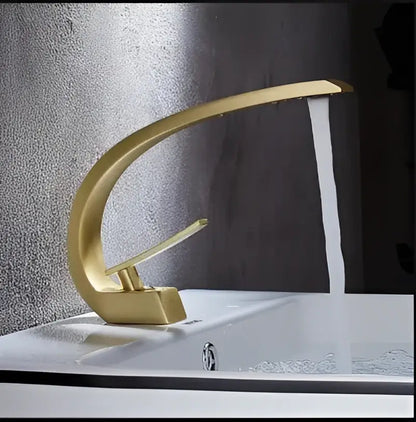 Gold modern basin faucet with sleek curved design in matte black and gold for bathroom use