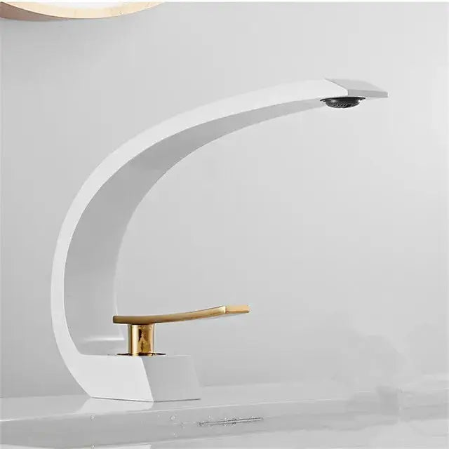Modern basin faucet white ceramic with sleek curved design and gold modern basin handle for bathroom use