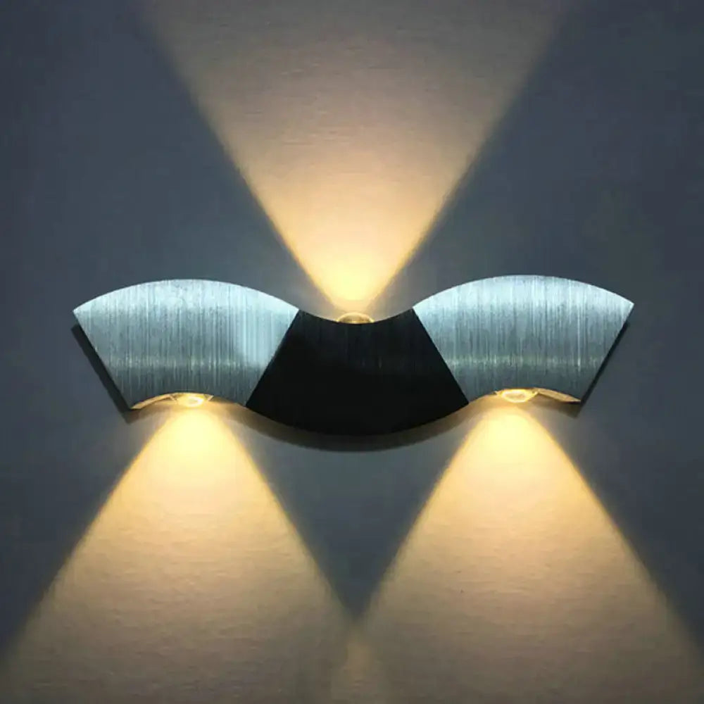 Modern matte black and gray sconce light with aluminum wave design featuring brushed silver and warm white lighting