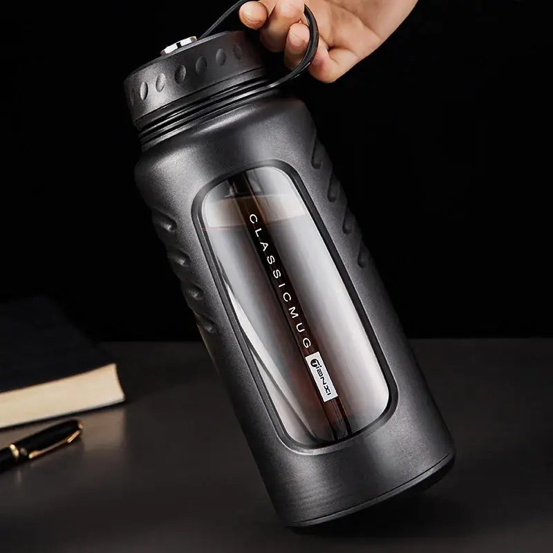 Modern matte black insulated glass water bottle with textured exterior and clear window revealing inner glass water cup
