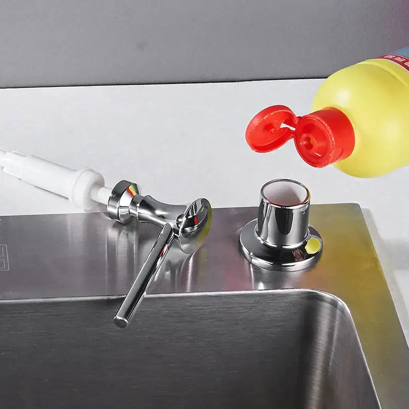 Modern matte black liquid soap dispenser with chrome finish and white pump handle for kitchen use