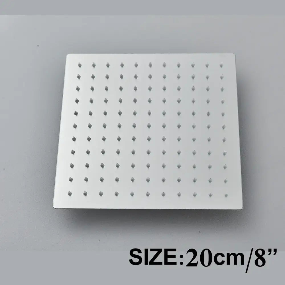 Modern matte black square shower head set with grid of small nozzles for a rainfall bathroom fixture