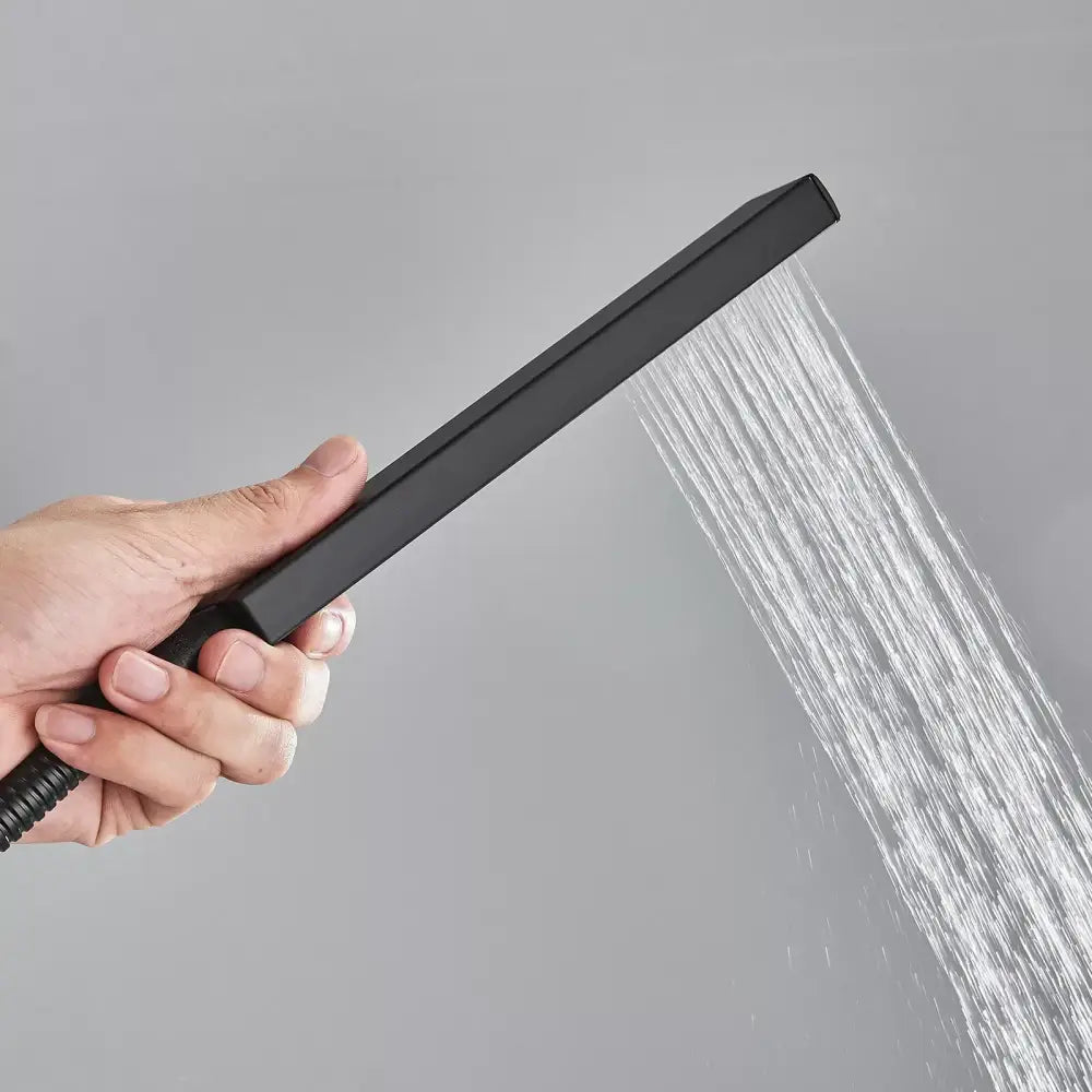 Black rectangular rainfall showerhead with sleek matte finish and multiple water jets in modern bathroom set