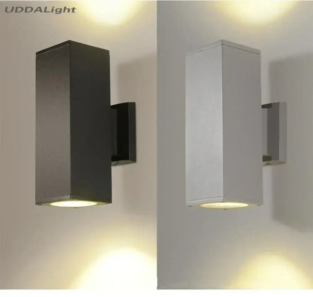 Modern matte black and silver outdoor wall lamp with sleek minimalist design and warm ambient lighting for garden use